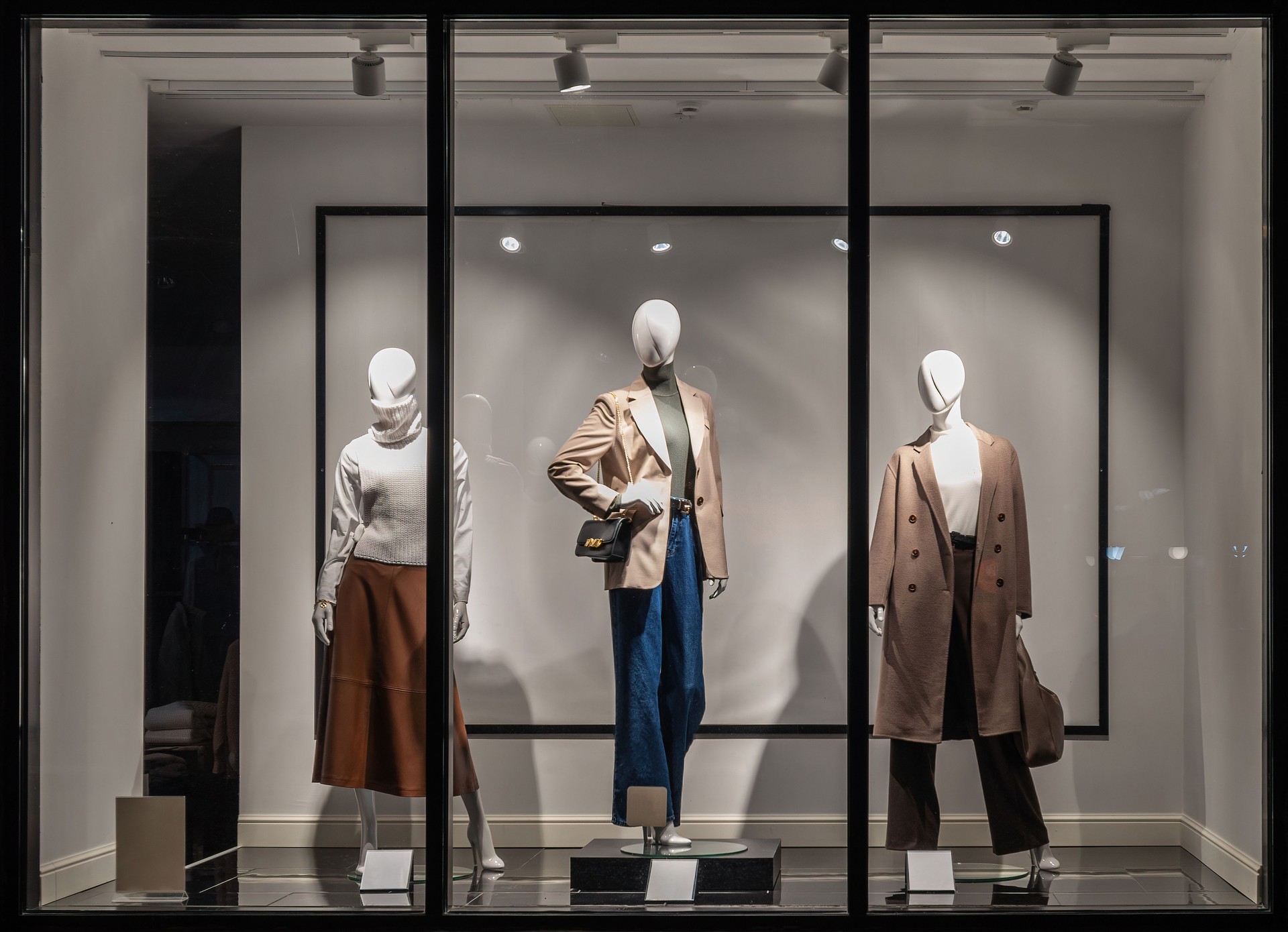 Fashion Store exterior. Shop windows and mannequins. City Night Boutique. Front View from street outdoor. LED light